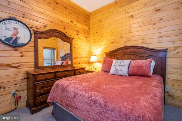 a bedroom with a bed and a closet with mirror