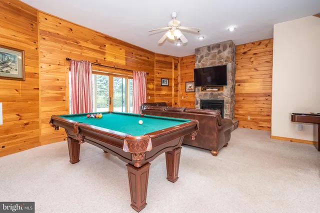 a room with pool table and windows