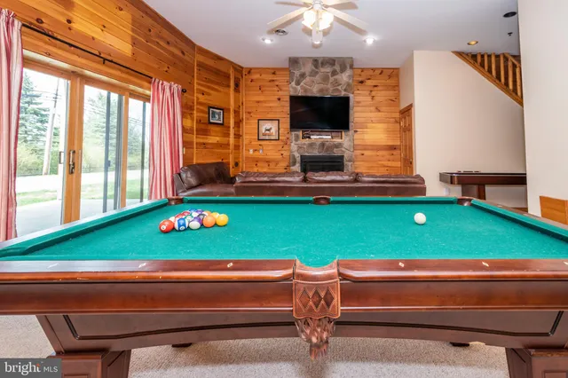 a room with pool table and flat screen tv