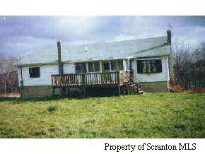 1493 Spring Hill Road Moscow, PA 18444 - Photo 1 of 1 a view of a house with backyard porch and furniture