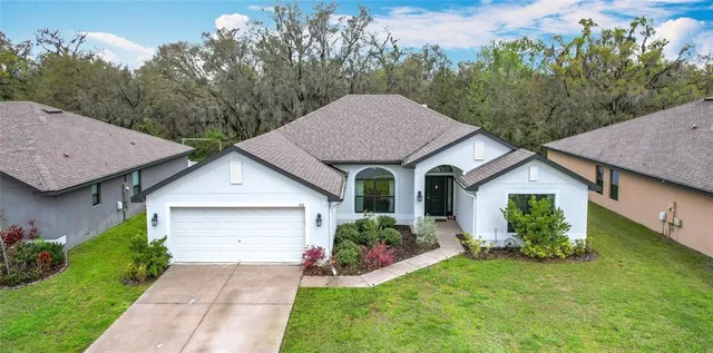 a front view of a house with a garden and plants