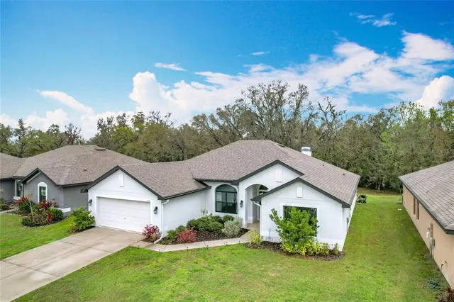 a aerial view of a house with table and chairs in a yard
