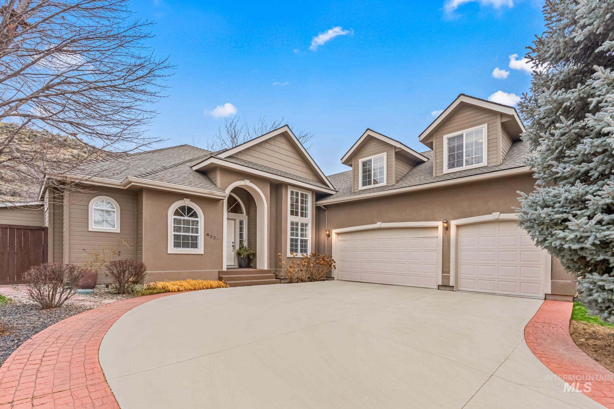 View of front of home featuring stucco siding, driveway, a shingled roof, and a garage