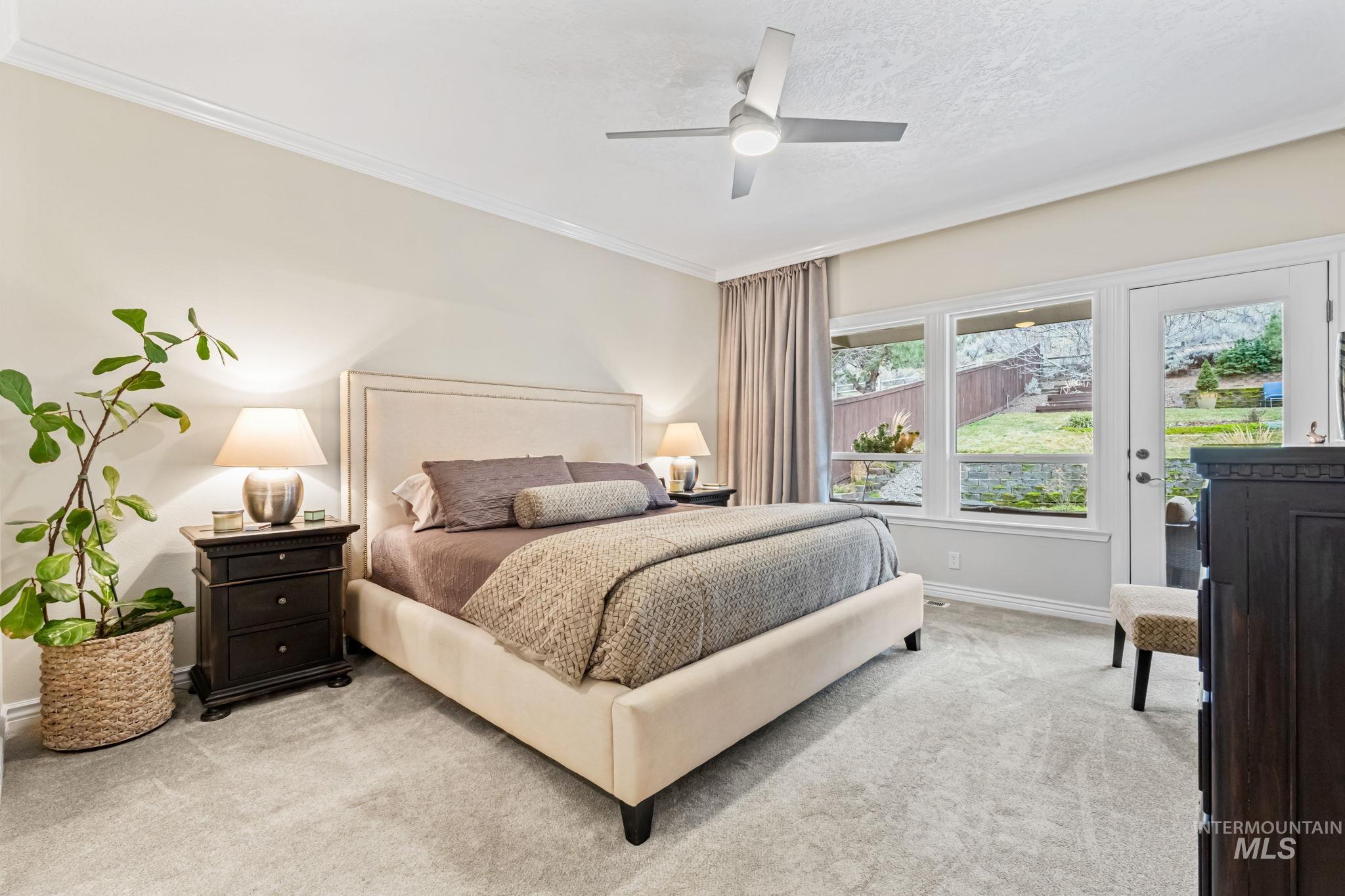 4235 Trekker Rim Drive East Boise, ID 83716 - Photo 15 of 33 Bedroom featuring carpet floors, access to outside, ceiling fan, and ornamental molding