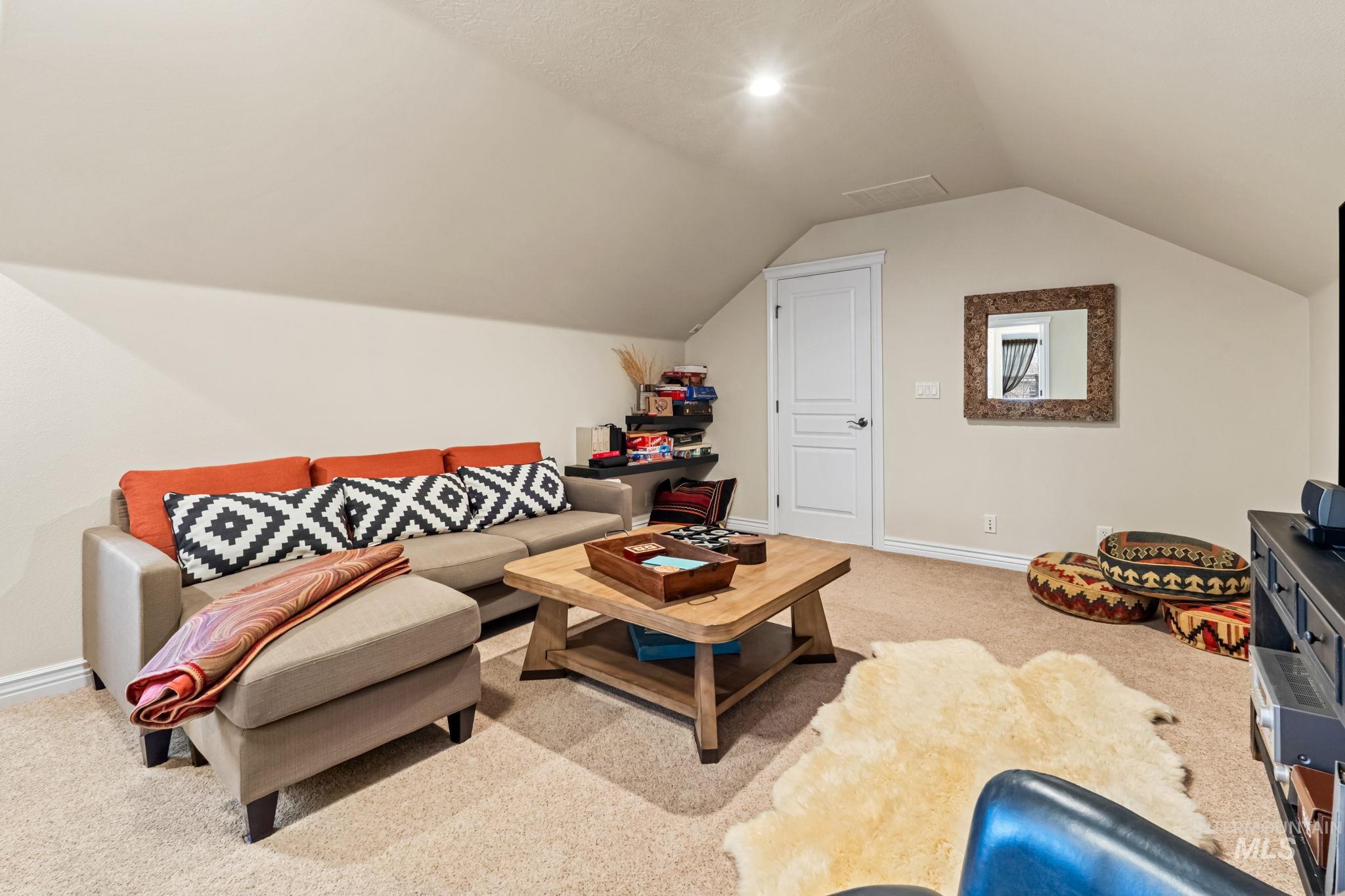 4235 Trekker Rim Drive East Boise, ID 83716 - Photo 20 of 33 Living area with light carpet and vaulted ceiling