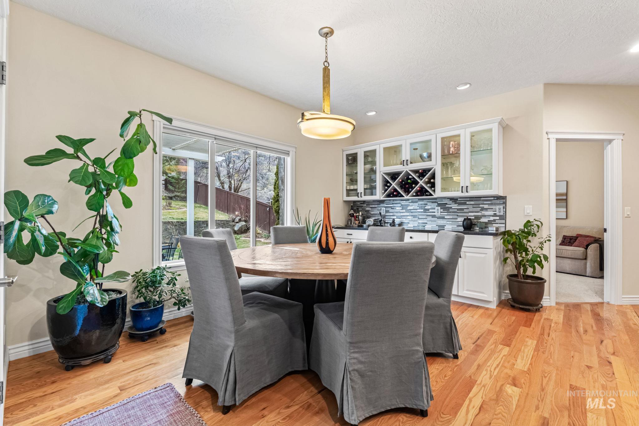 4235 Trekker Rim Drive East Boise, ID 83716 - Photo 8 of 33 Dining area with bar area, recessed lighting, and light wood-style floors