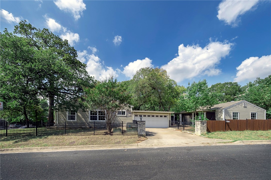 a view of a house with a patio and a yard