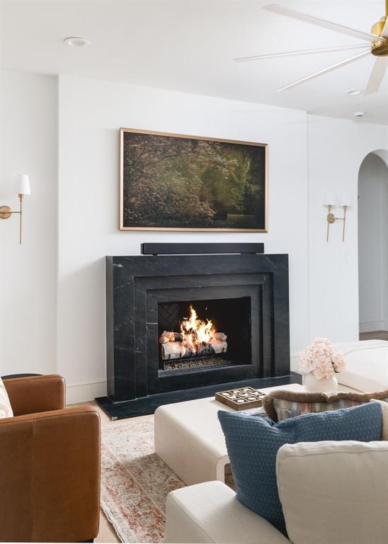 3963 Rochelle Drive Dallas, TX 75220 - Photo 10 of 40 Black stone fireplace surround with a dark herringbone interior