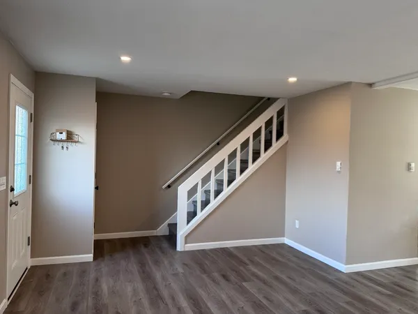 a view of an empty room with wooden floor
