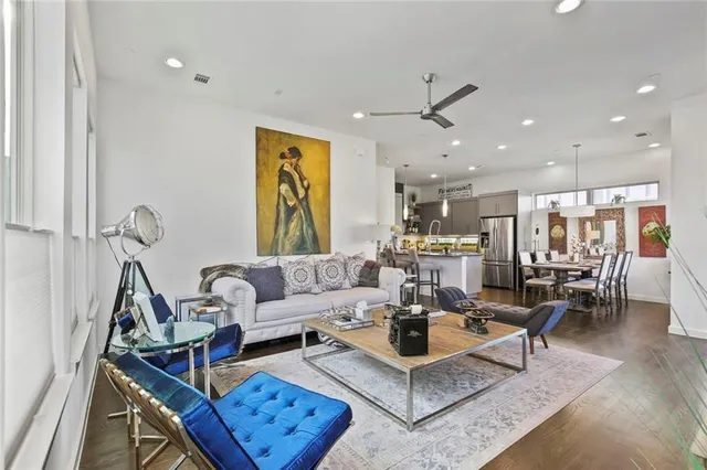 a living room with furniture a rug and white walls