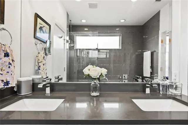 a bathroom with a sink a toilet and a mirror