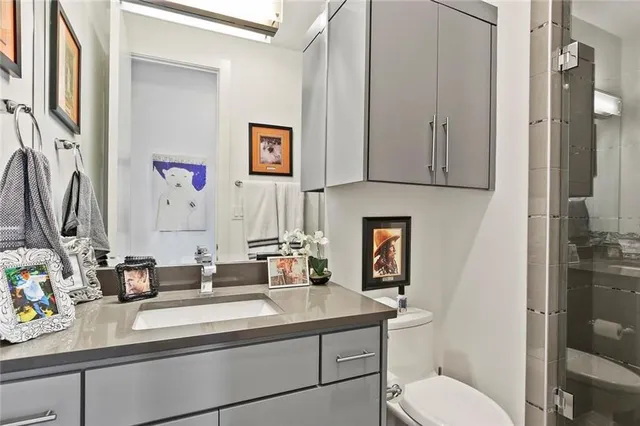 a bathroom with a toilet sink and mirror