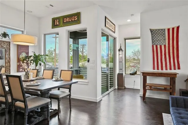 a dining room with furniture and wooden floor