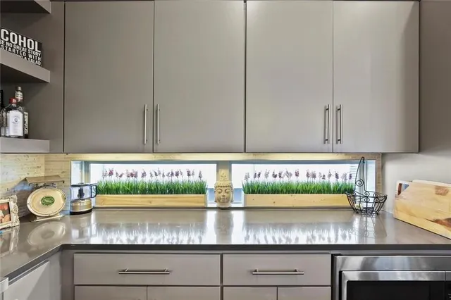 a kitchen with stainless steel appliances granite countertop a table and a stove