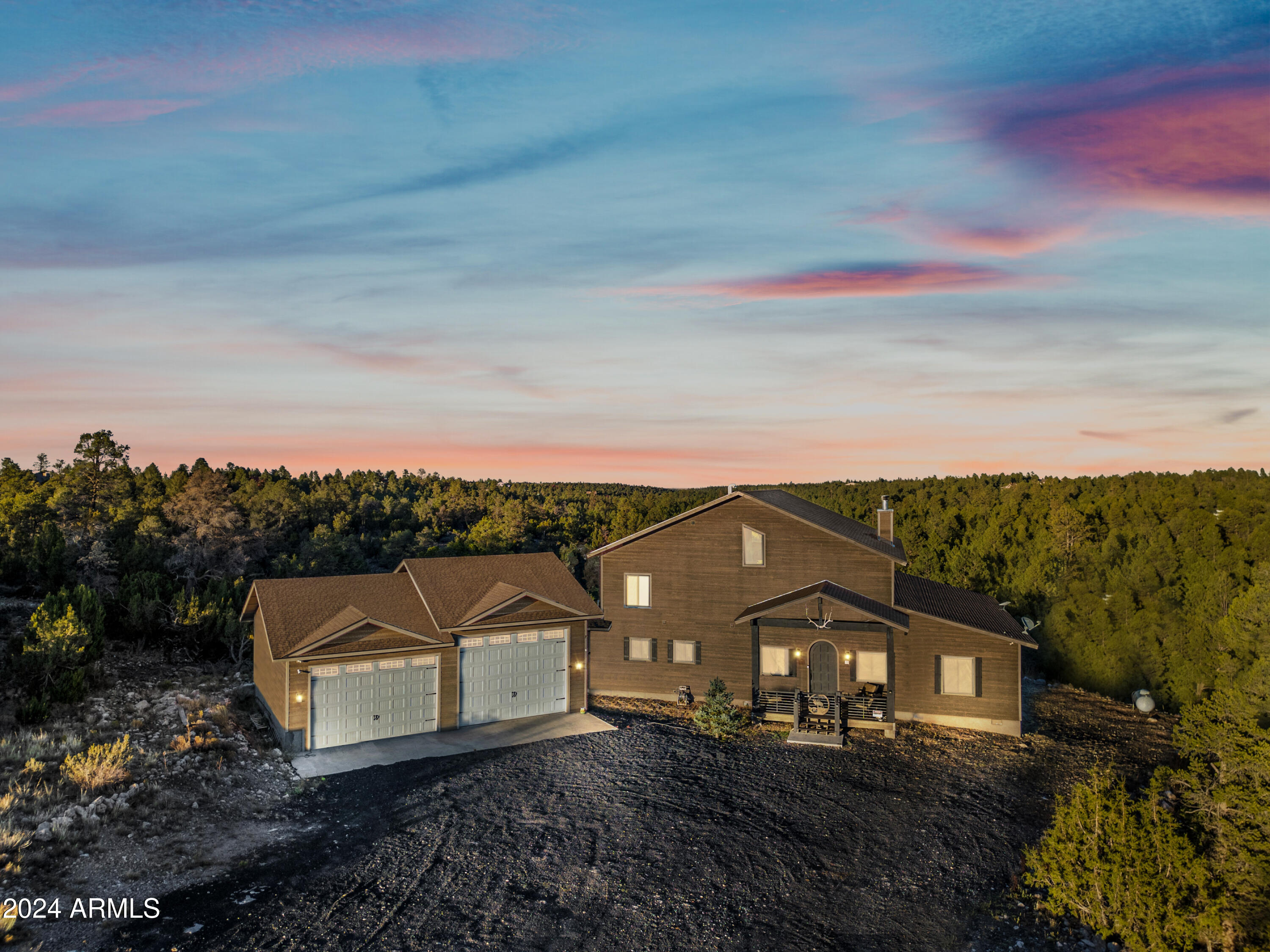 a view of a large house with a big yard and large trees