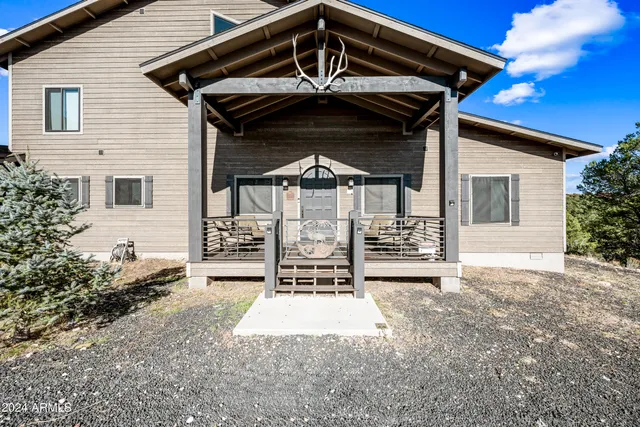 a living room with a fireplace and wooden floor