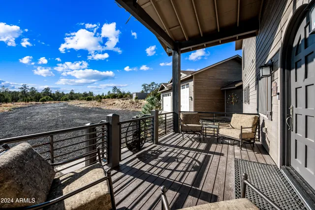 a kitchen with granite countertop a sink a center island stainless steel appliances and cabinets