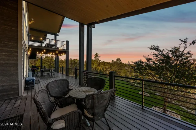 a spacious bedroom with a bed and a flat screen tv