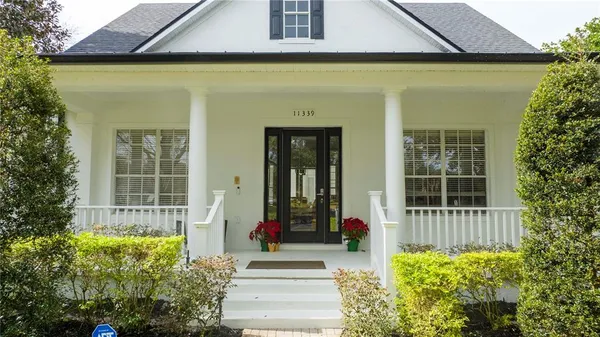 an aerial view of a house with swimming pool and garden space