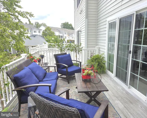 a outdoor sitting area with furniture and wooden floor