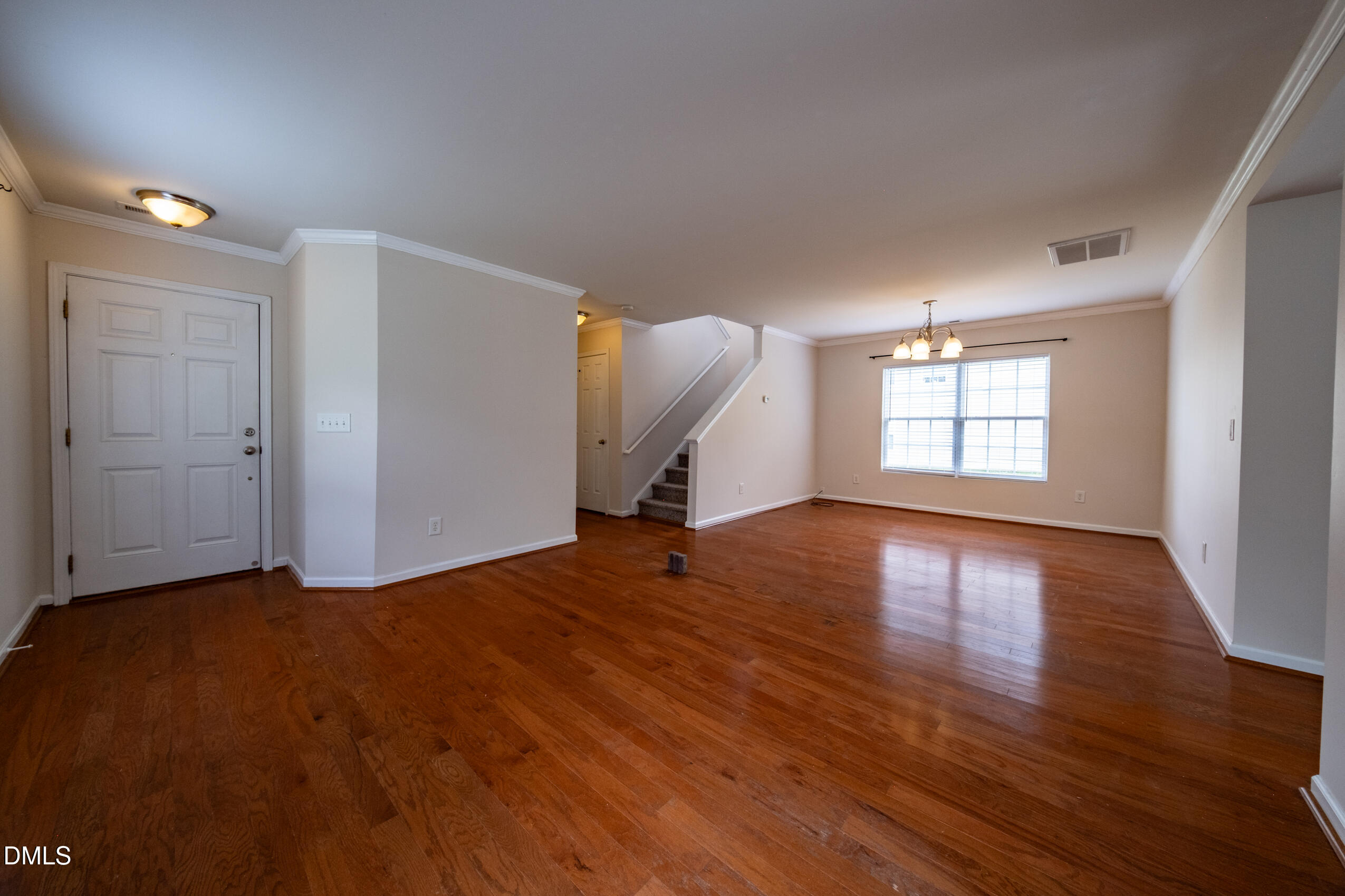 719 Obsidian Way Durham, NC 27703 - Photo 7 of 41 an empty room with wooden floor and windows
