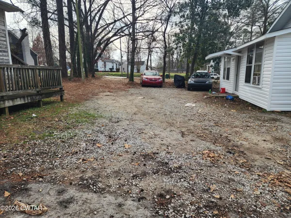 a view of a house with a yard and sitting area