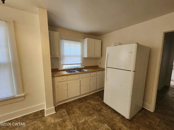 a kitchen with a refrigerator and a stove