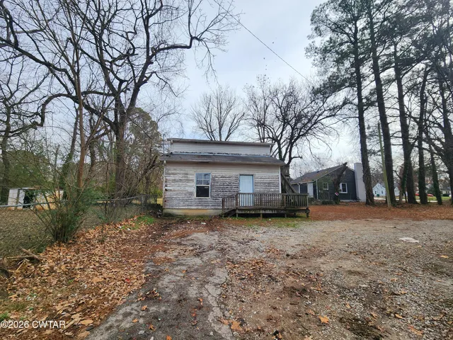 a house that has a tree in front of it