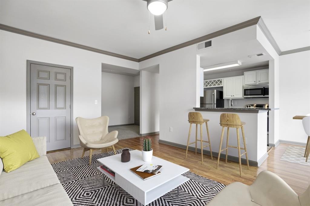 2000 Monroe Place Northeast, Unit 1306 Atlanta, GA 30324 - Photo 2 of 18 a living room with furniture a rug kitchen view and a table