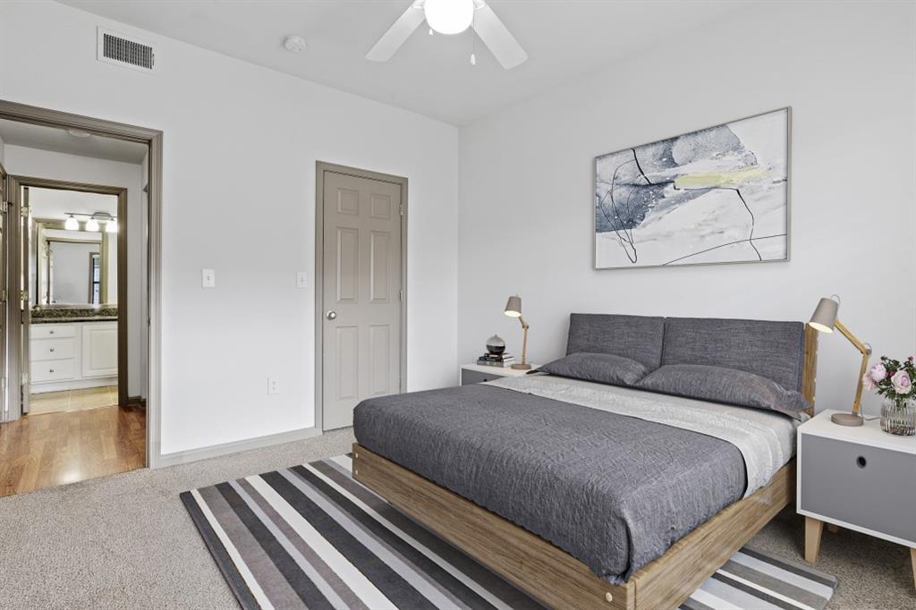 2000 Monroe Place Northeast, Unit 1306 Atlanta, GA 30324 - Photo 6 of 18 a bedroom with a bed and a chandelier