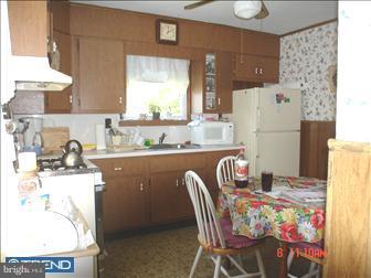 508 Bonsall Road Ridley Park, PA 19078 - Photo 3 of 6 a kitchen with a refrigerator and a table in it