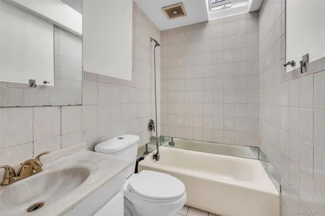 a bathroom with a sink a toilet and bathtub