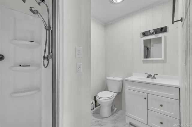 a white toilet sitting next to a bathroom sink