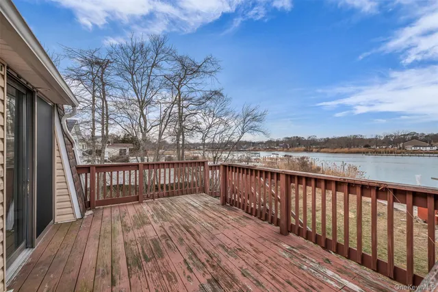 a view of balcony with wooden floor and fence