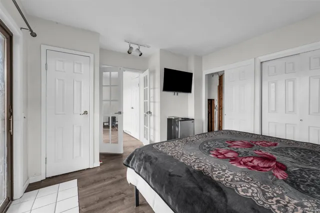 a bedroom with a bed and a flat screen tv