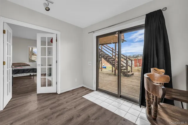 a view of a hallway with wooden floor and a living room