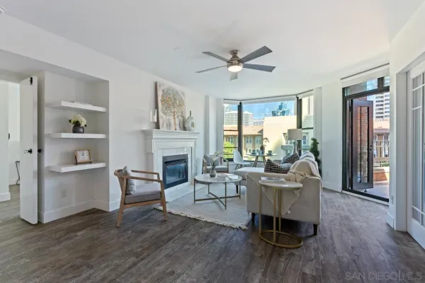 a living room with fireplace furniture and a wooden floor