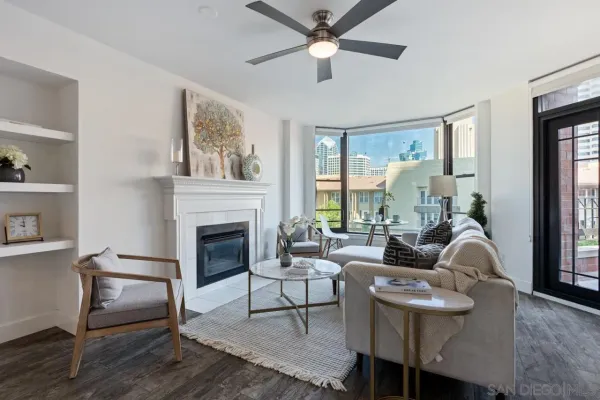 a living room with furniture fireplace and window