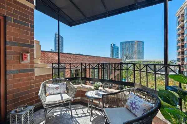 a balcony with table and chairs