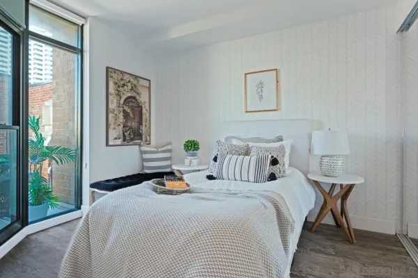 a bedroom with a bed and a painting on the wall