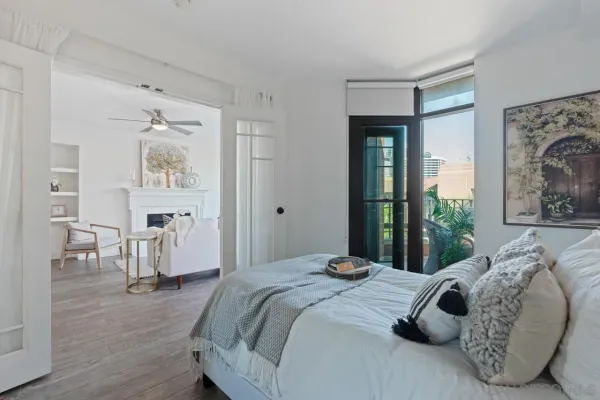 a bedroom with bed and wooden floor