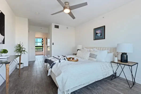 a bedroom with a bed and wooden floor