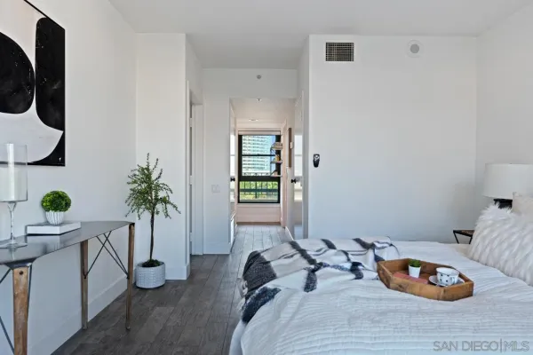 a bedroom with bed and a potted plant