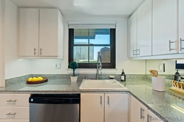 a kitchen with a sink a stove cabinets and counter space