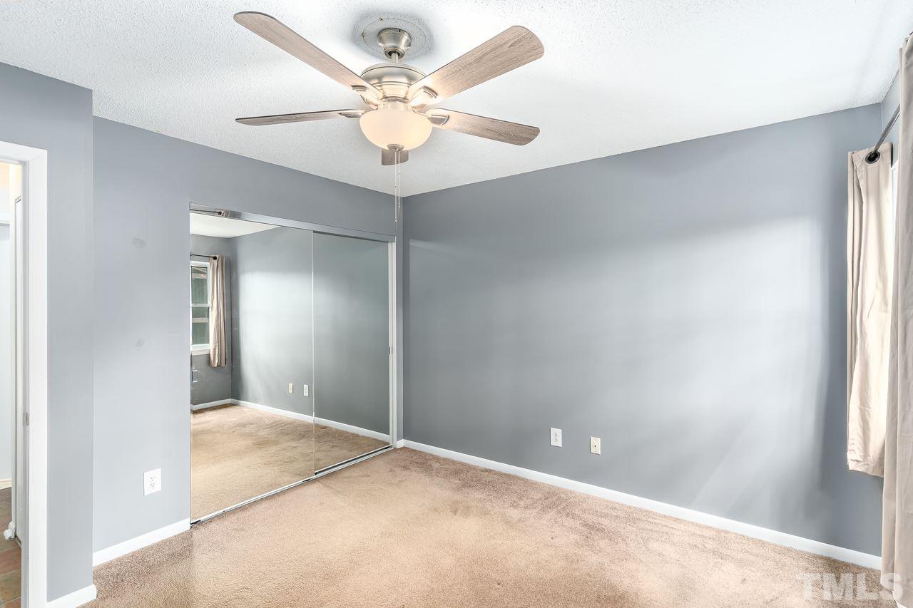 707 Godwin Court Raleigh, NC 27606 - Photo 12 of 26 an empty room with fan and windows