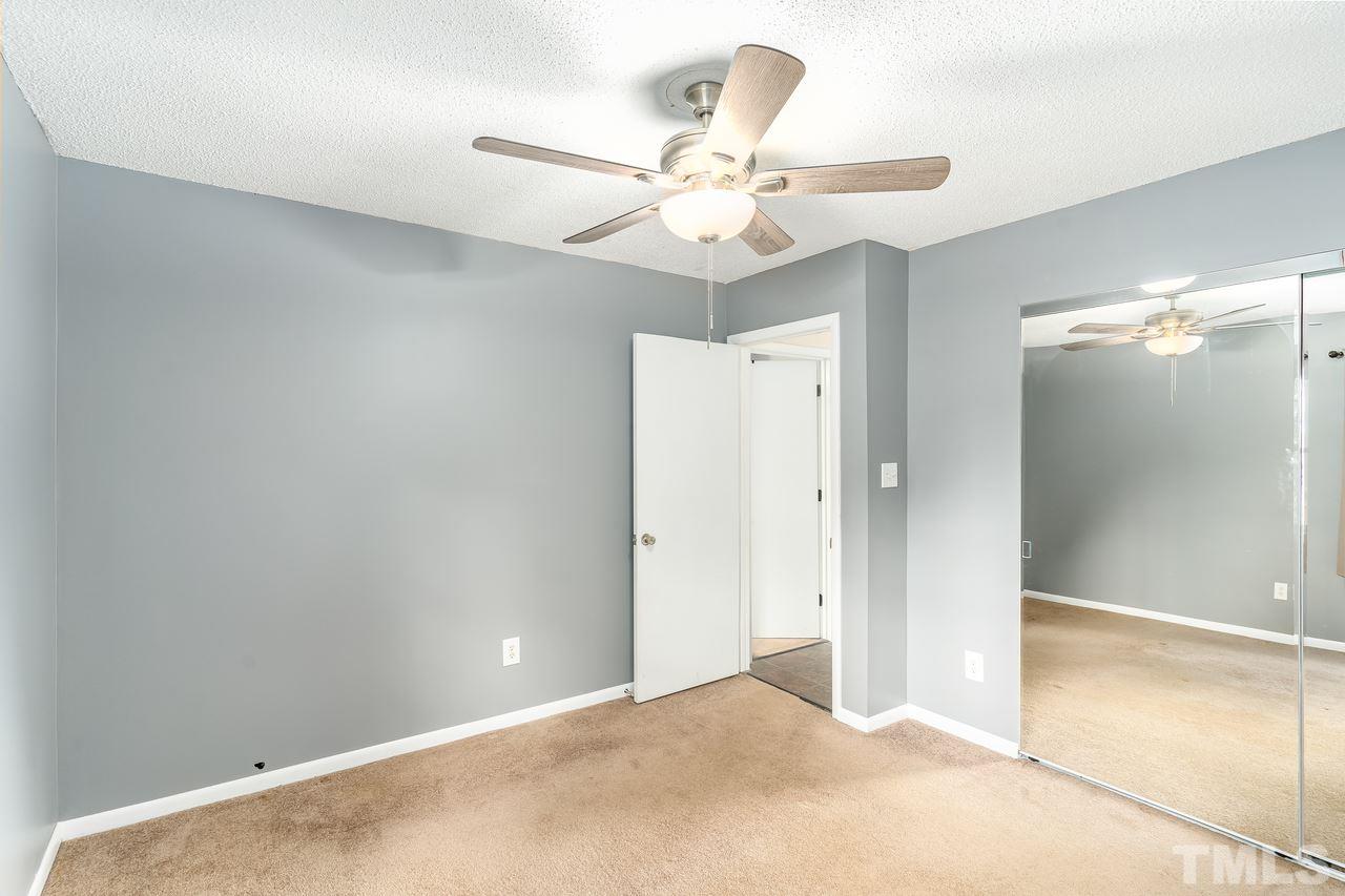 707 Godwin Court Raleigh, NC 27606 - Photo 13 of 26 an empty room with a fan and a fan