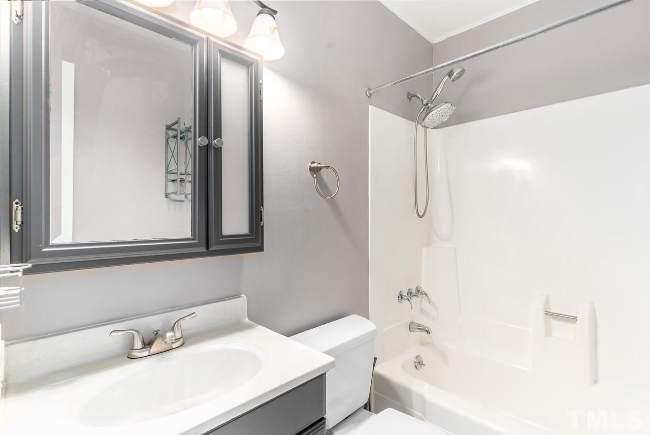 707 Godwin Court Raleigh, NC 27606 - Photo 14 of 26 a bathroom with a sink toilet and shower