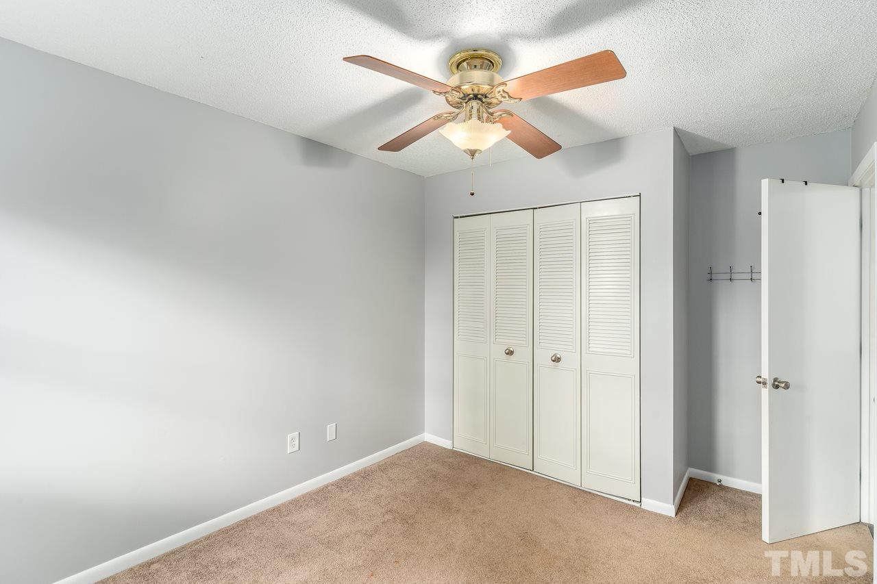 707 Godwin Court Raleigh, NC 27606 - Photo 15 of 26 an empty room with windows and fan