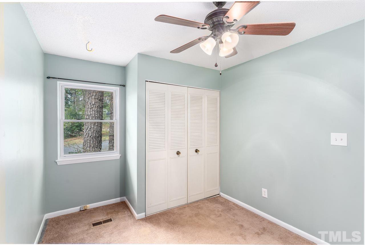 707 Godwin Court Raleigh, NC 27606 - Photo 17 of 26 an empty room with windows and fan
