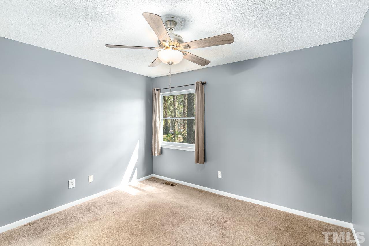 707 Godwin Court Raleigh, NC 27606 - Photo 18 of 26 an empty room with a window and a fan